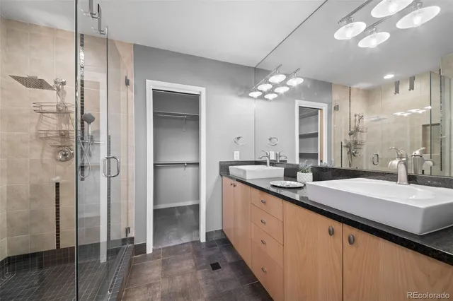 a bathroom with a double vanity sink and a mirror