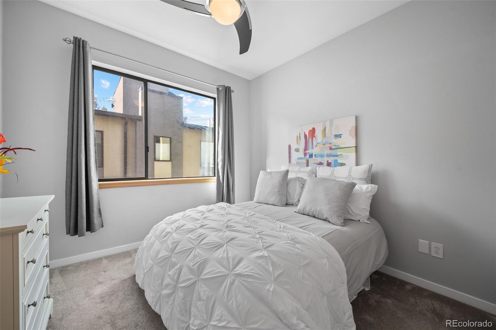 516 24th Street Denver, CO 80205 - Photo 19 of 42 a bedroom with a large bed and a large window