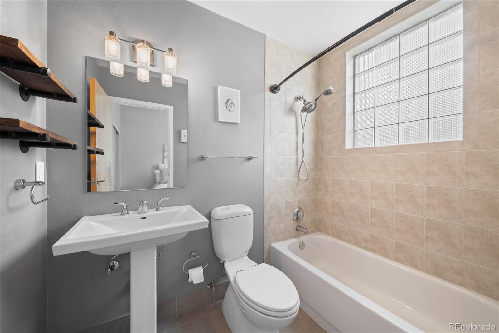 516 24th Street Denver, CO 80205 - Photo 21 of 42 a bathroom with a sink a toilet and shower