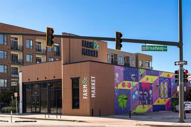 a view of a building and car parked on the street