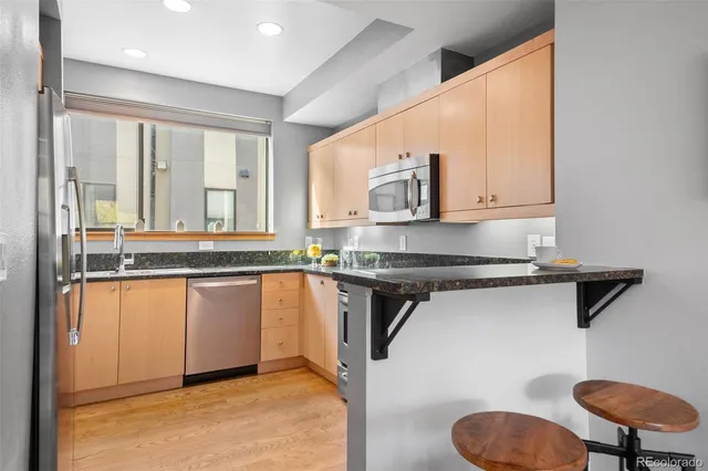 a kitchen with a sink cabinets and a window