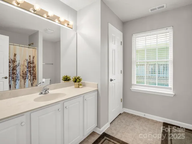 a hallway with a window in a white room