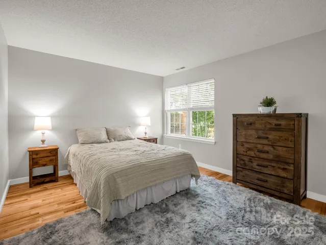 a bedroom with a bed and a plant