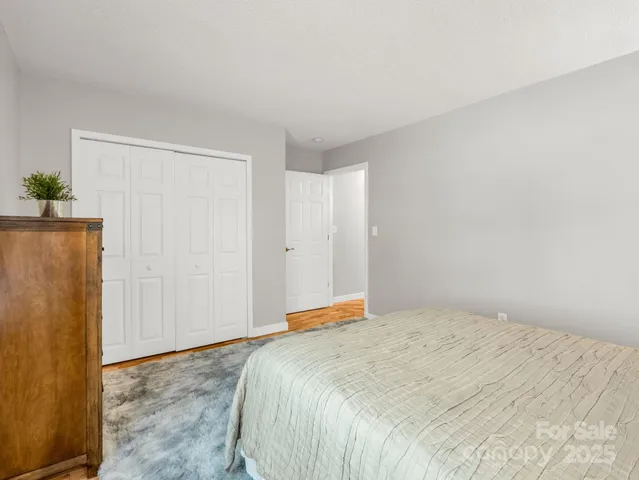 a living room with furniture a flat screen tv and a window