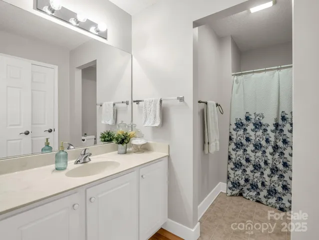 a bathroom with a shower curtain and toilet