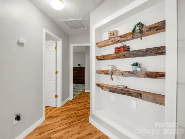 a kitchen with stainless steel appliances granite countertop a stove and white cabinets