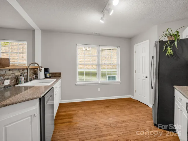 a kitchen with a sink cabinets and window