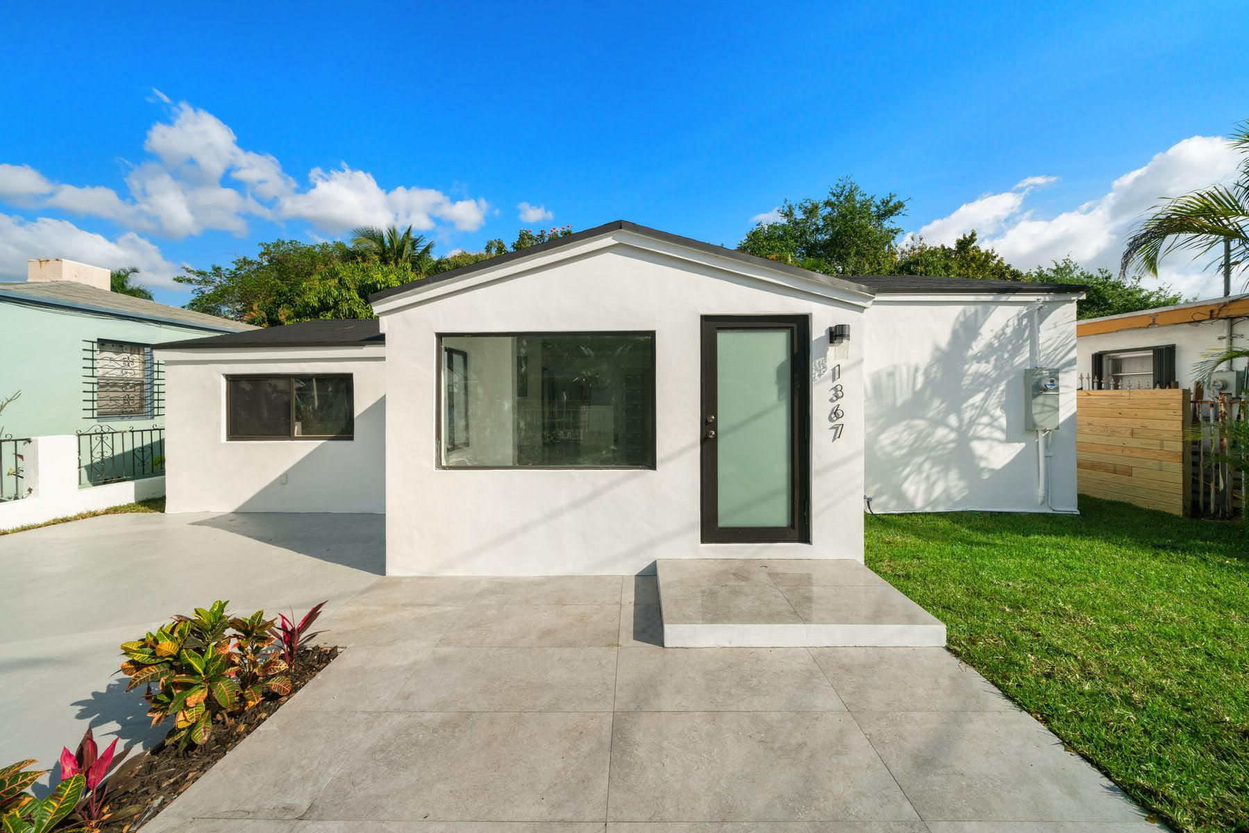1367 Northwest 41st Street Miami, FL 33142 - Photo 1 of 20 a front view of a house with a yard and garage