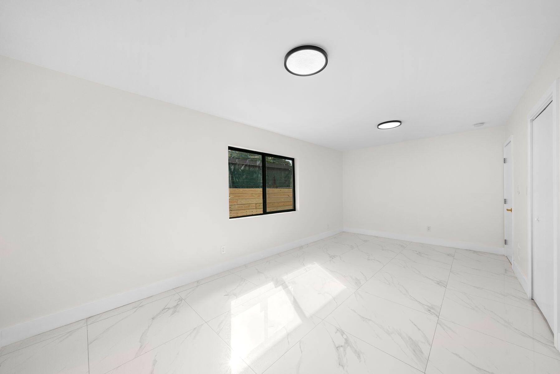 1367 Northwest 41st Street Miami, FL 33142 - Photo 11 of 20 a view of an empty room with a window