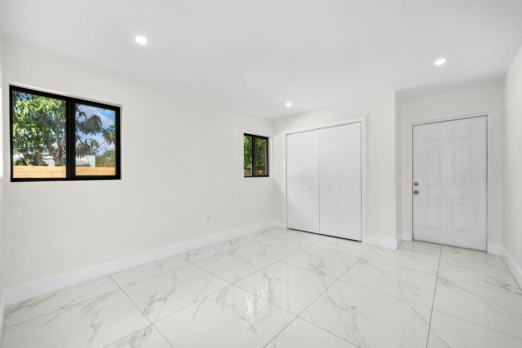 1367 Northwest 41st Street Miami, FL 33142 - Photo 12 of 20 a view of an empty room with a window