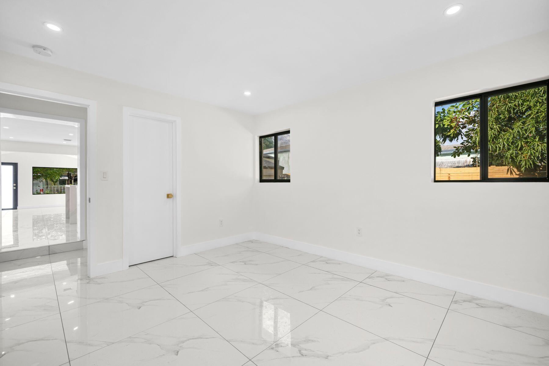 1367 Northwest 41st Street Miami, FL 33142 - Photo 13 of 20 an empty room with windows