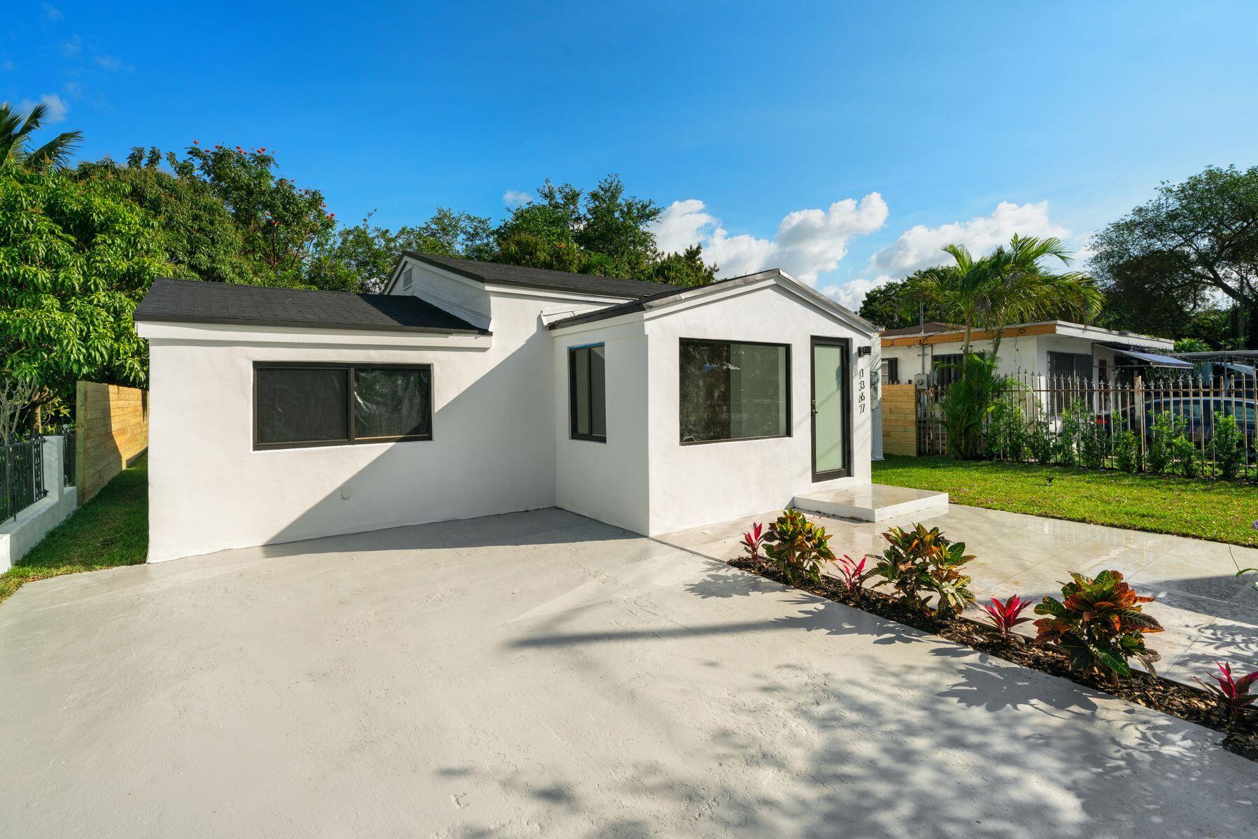 1367 Northwest 41st Street Miami, FL 33142 - Photo 2 of 20 a front view of a house with a yard