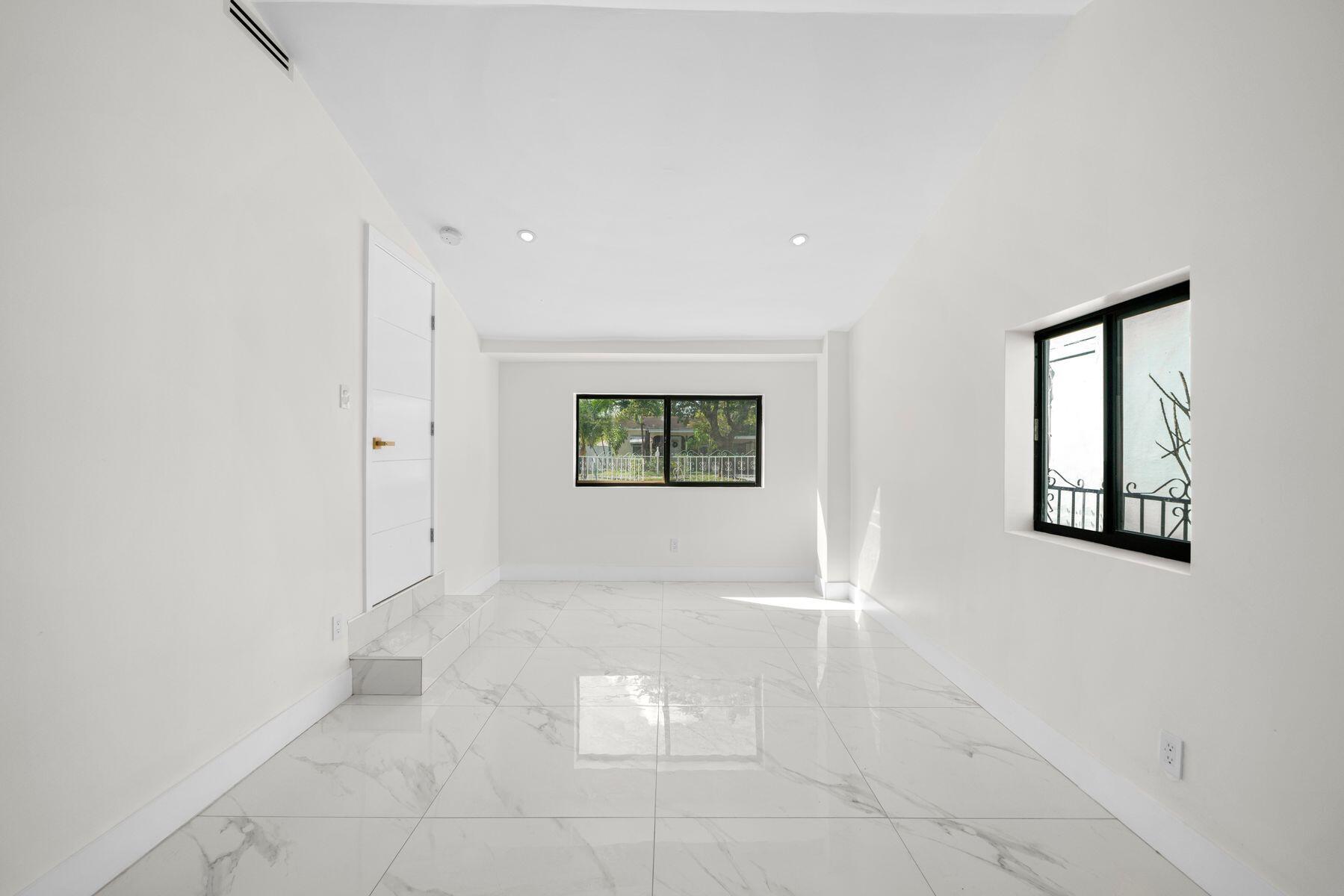 1367 Northwest 41st Street Miami, FL 33142 - Photo 9 of 20 an empty room with windows and closet
