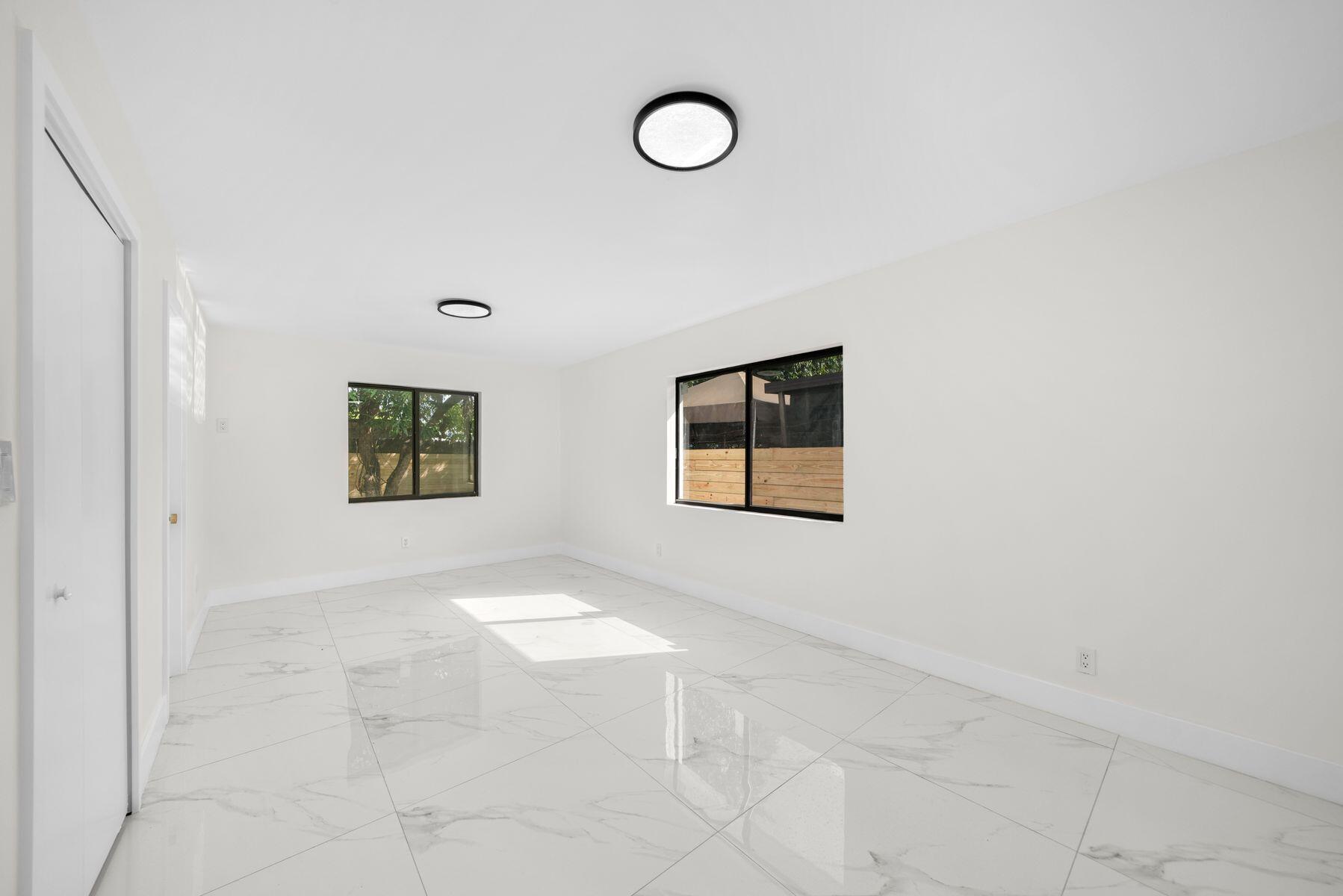 1367 Northwest 41st Street Miami, FL 33142 - Photo 10 of 20 a view of a room with floor to white walls