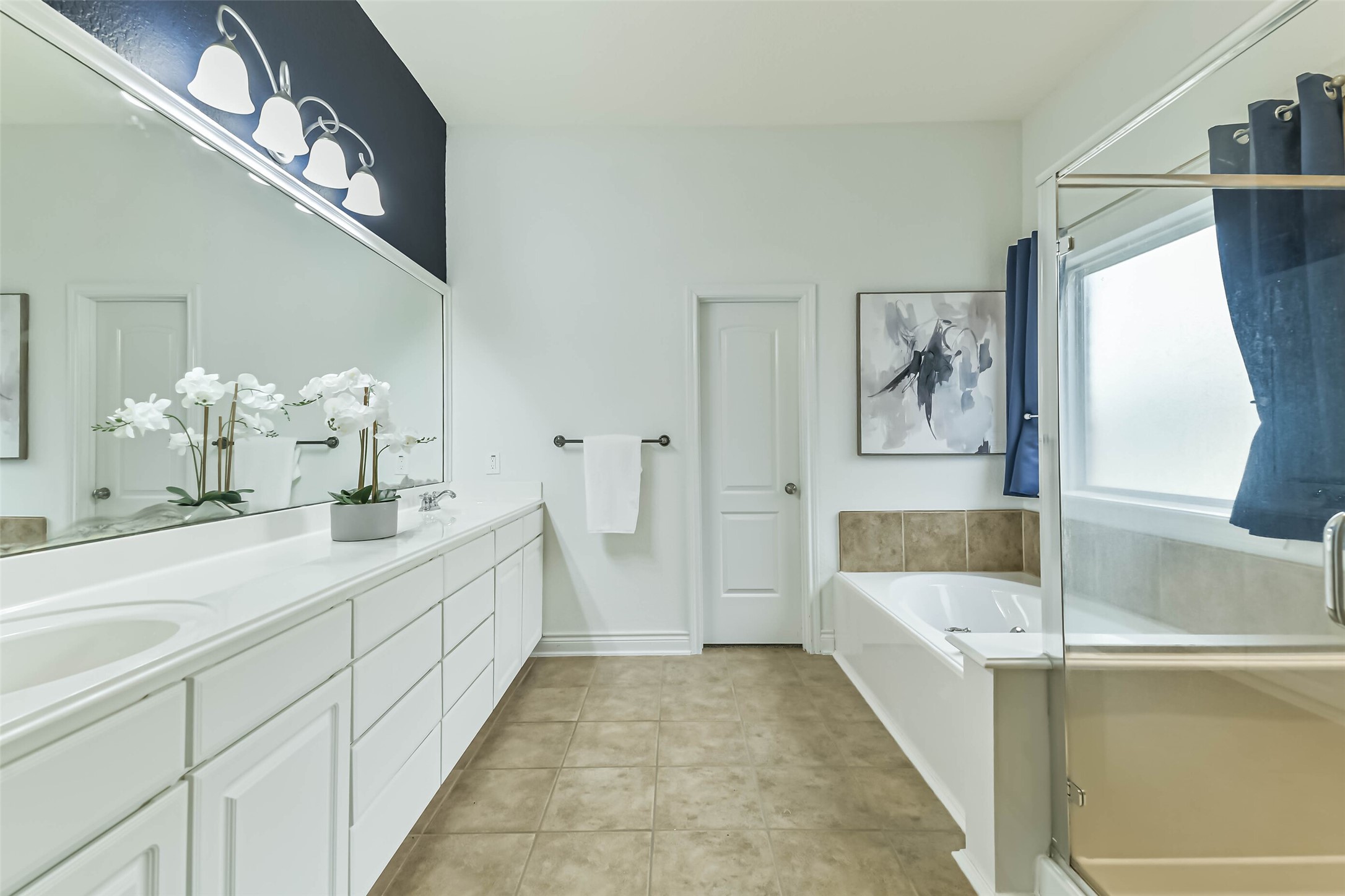 19022 Greenleaf Ridge Court Cypress, TX 77429 - Photo 26 of 47 a bathroom with a tub sink and mirror