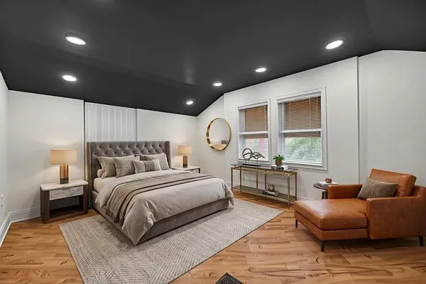 a spacious bedroom with a large bed and a chandelier