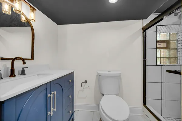 a bathroom with a sink mirror vanity and toilet