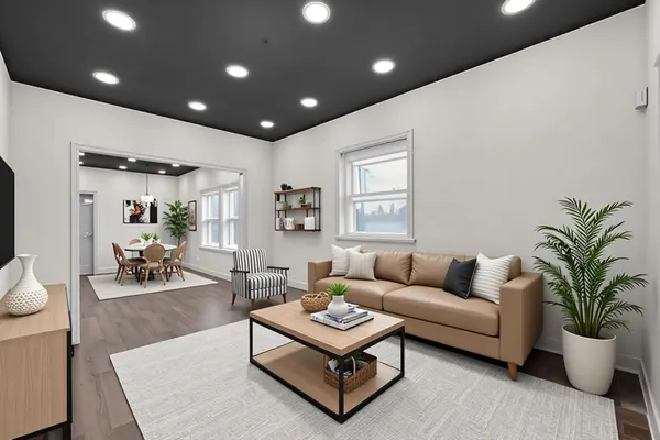 a living room with furniture potted plant and a window
