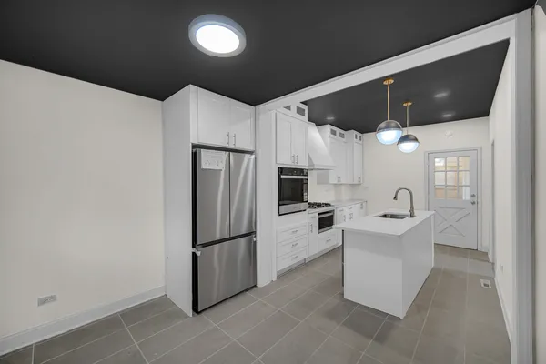 a kitchen with stainless steel appliances a refrigerator and a microwave