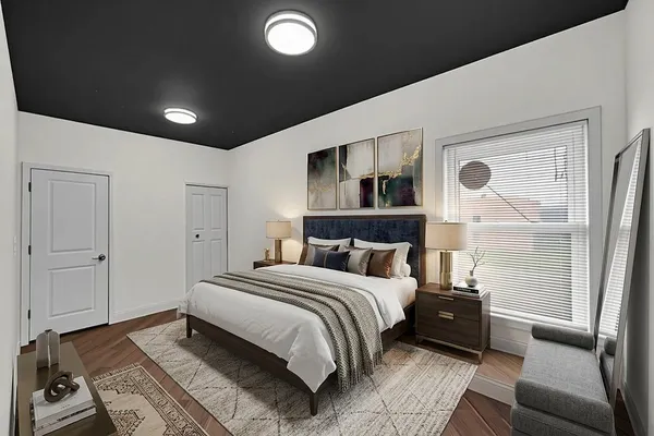 a bedroom with a large bed and a couch