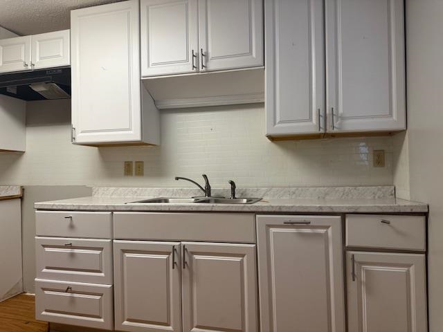 1688 Pendleton Street Memphis, TN 38114 - Photo 7 of 17 a kitchen with granite countertop white cabinets and a sink