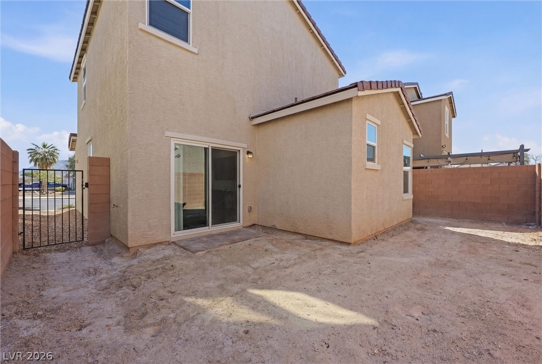1811 Lincoln Road Las Vegas, NV 89115 - Photo 5 of 30 Rear view of property with stucco siding, a gate, and a patio area