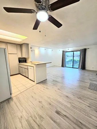 a view of a kitchen with a stove cabinets and wooden floor