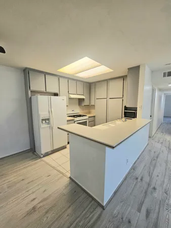 a kitchen with stainless steel appliances a refrigerator and a stove top oven