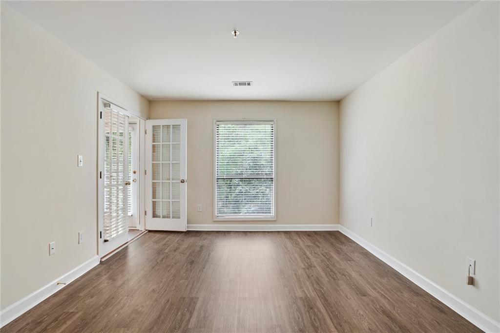 3203 Lenox Road Northeast, Unit 6 Atlanta, GA 30324 - Photo 10 of 27 an empty room with wooden floor and windows