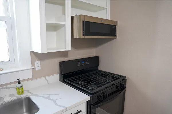 a kitchen with a stove and a microwave