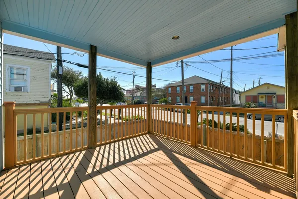 a view of a balcony with wooden floor