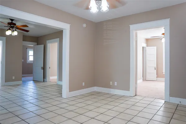 a view of a hallway with wooden floor and chandelier