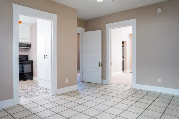 a view of a room with wooden floor and cabinet