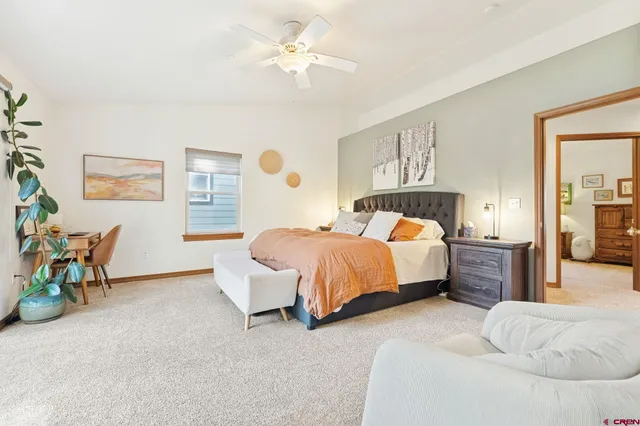 a spacious bedroom with a bed and a table