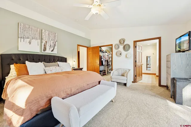 a bedroom with a large bed and a chandelier