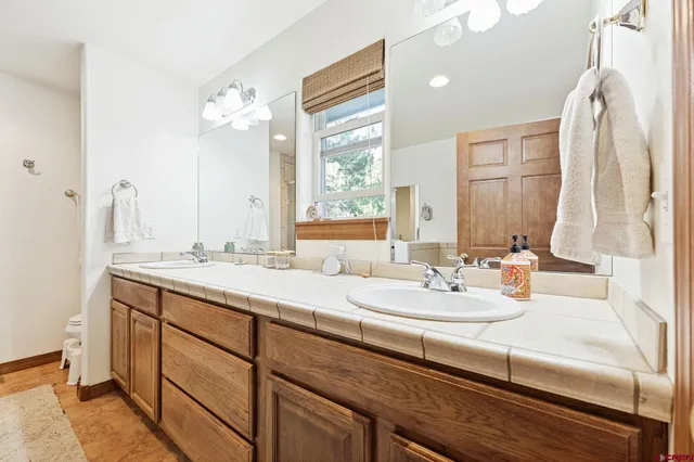 a bathroom with a double vanity sink and mirror