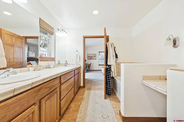 a spacious bathroom with a double vanity sink and mirror
