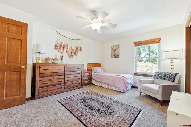 a spacious bedroom with a bed and furniture