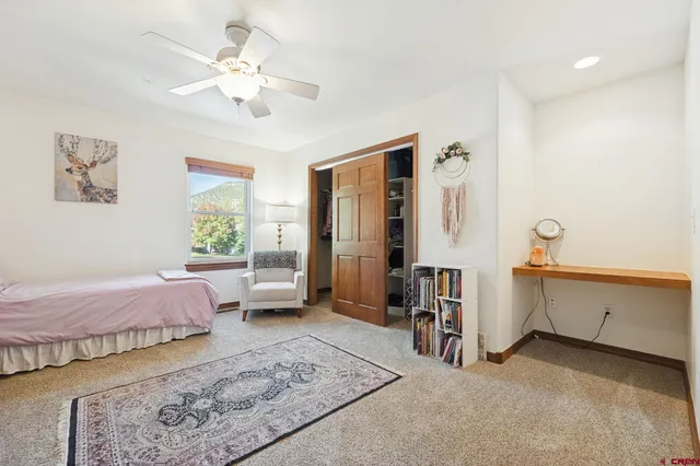 a spacious bedroom with a bed and a chandelier