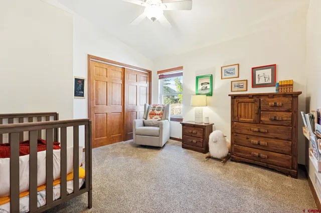 a bedroom with furniture and a baby crib