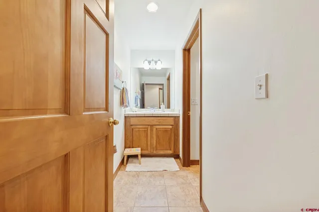 a view of a bathroom with sink and mirror
