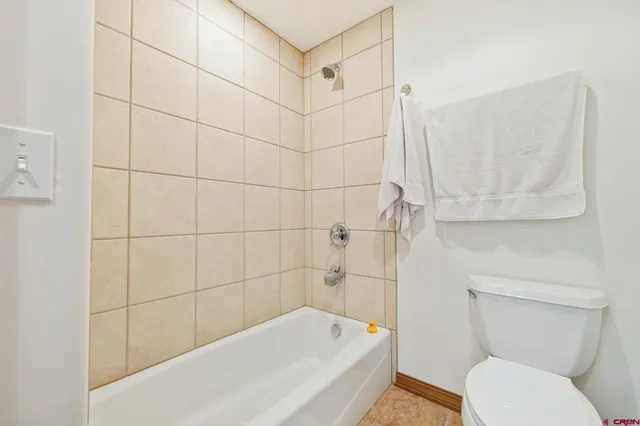 a bathroom with a toilet and shower