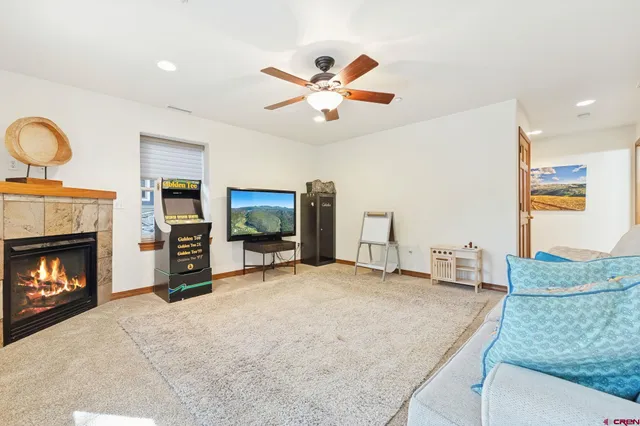 a living room with furniture a flat screen tv and a large window
