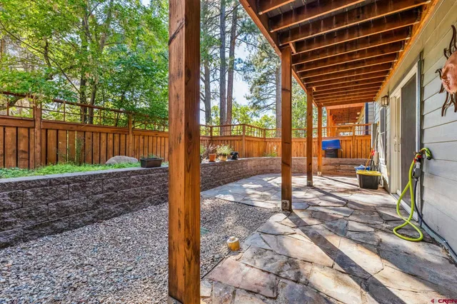 a view of a house with backyard and wooden fence