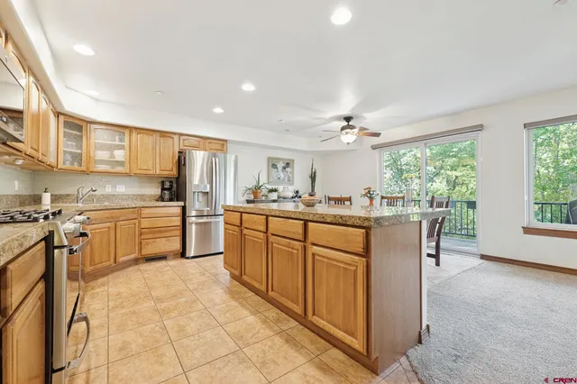 a kitchen with a stove sink cabinets and appliances
