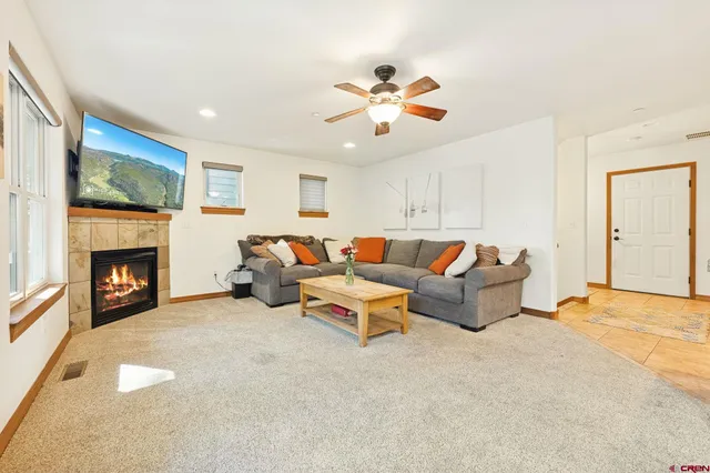 a living room with furniture and a fireplace