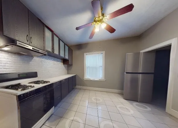 a kitchen with stainless steel appliances granite countertop a stove a refrigerator and a cabinets