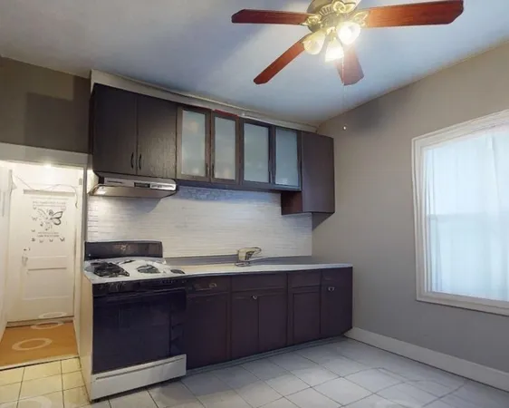 a kitchen with stainless steel appliances granite countertop a sink a stove and a refrigerator