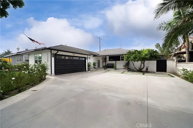 a view of a house with a yard and a garage
