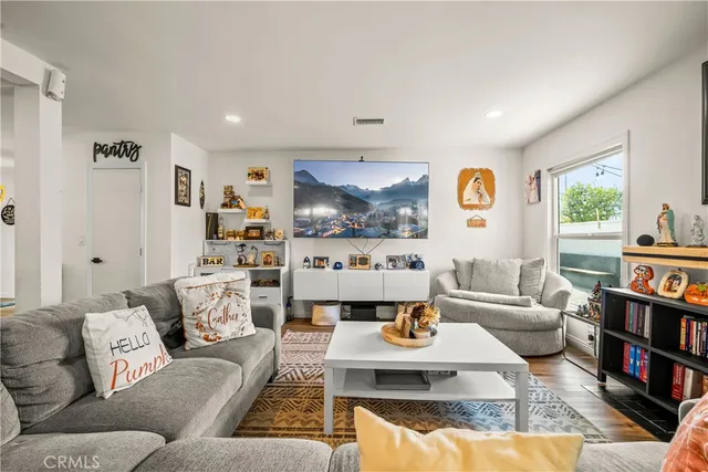 a living room with furniture and a book shelf